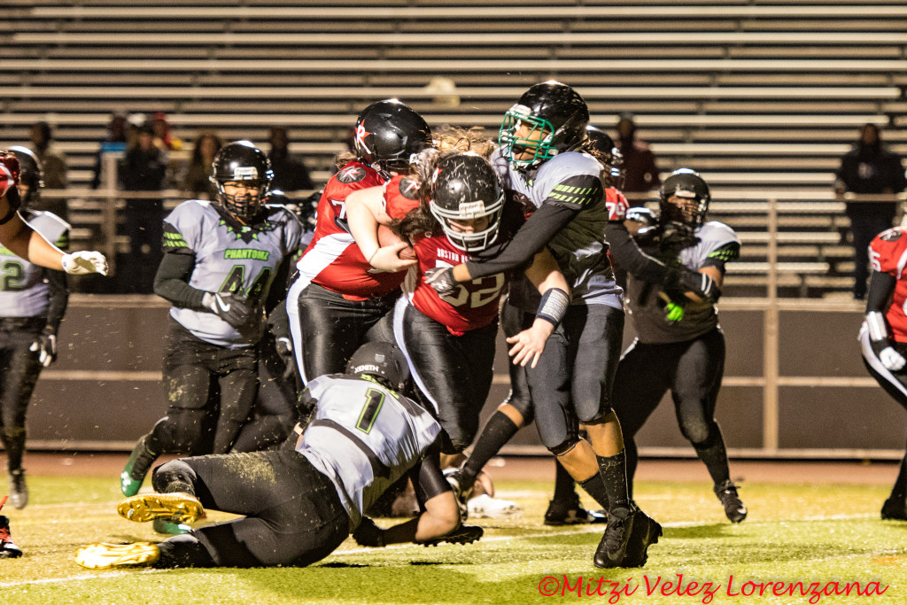 Philadelphia Phantomz players attempt to wrap up ball carrier Allie Genereux #52 of the Boston Renegades when the teams played on April 7, 2018. © 2018 Mitzi Velez Lorenzana.