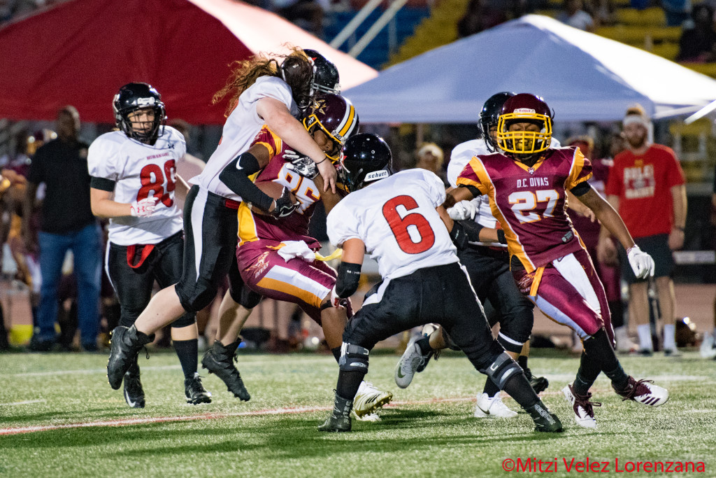 Allie Genereux and Brooke Gause tackle Kentrina Wilson