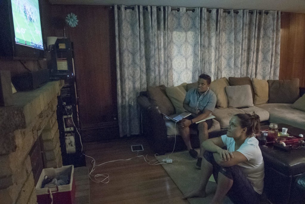 Linebackers Mia Brickhouse (left) and Jessica Penta (right) study film at Penta's house the night before their playoff game against the Chicago Force, July 9. Penta says that she gets nervous before games so it helps her to stay occupied. (Wicked Local Staff Photo /Sam Goresh)